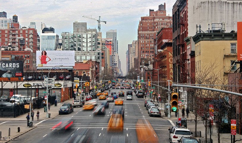 Taxis blurring down a Manhattan avenue