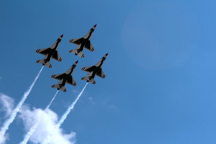 Four Thunderbirds jets climbing in formation